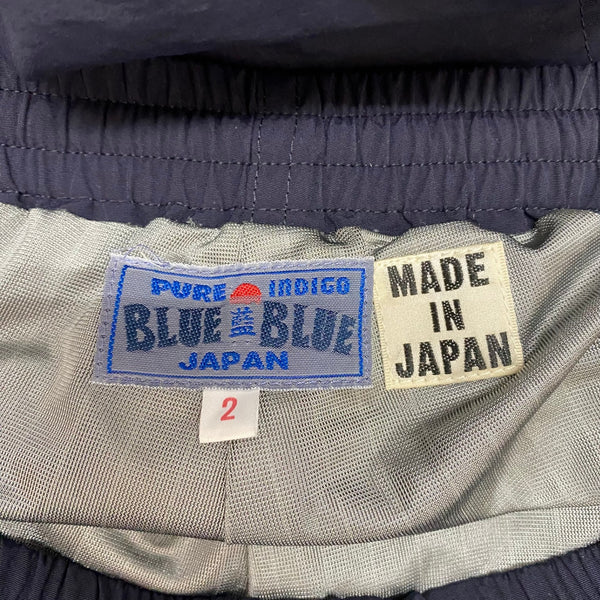 ブルーブルー BLUE BLUE ナイロンリフレクタープリント ウォームアップパンツ 1002168 ボトムスその他 ブラック 2サイズ 201MB-868